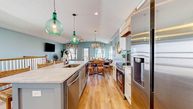 16/18/20 Inlet Pl, Saint Augustine, FL 32080 - kitchen with stainless steel appliances, a sink, light wood-style flooring, a center island with sink, and pendant lighting