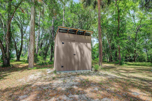view of shed featuring a wooded view