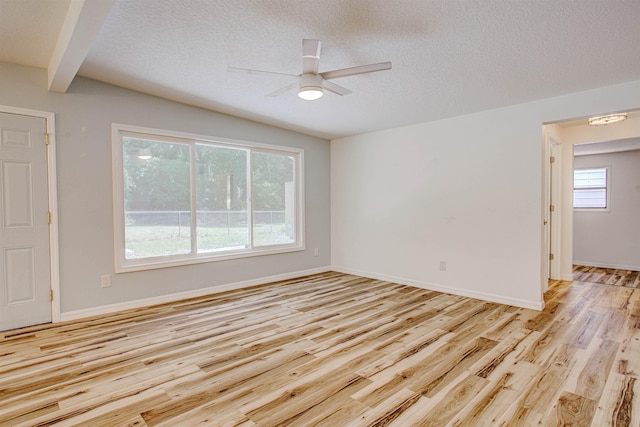 unfurnished room with light wood finished floors, baseboards, a textured ceiling, and ceiling fan