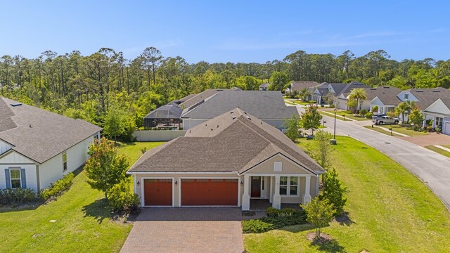 443 Pescado Dr, Saint Augustine, FL 32095 - view of front of home featuring a garage, a residential view, decorative driveway, and a front lawn
