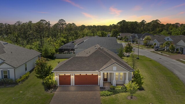 443 Pescado Dr, Saint Augustine, FL 32095 - view of front of property with a front yard, a residential view, decorative driveway, and an attached garage