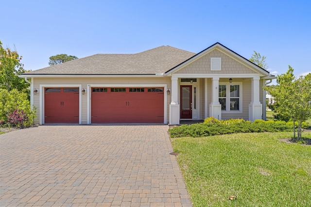 443 Pescado Dr, Saint Augustine, FL 32095 - view of front of house with a front lawn, a shingled roof, a garage, and decorative driveway