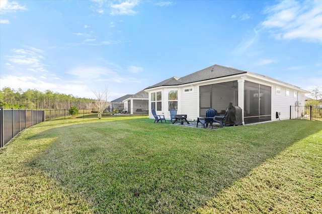 rear view of property featuring a sunroom, a lawn, and a patio