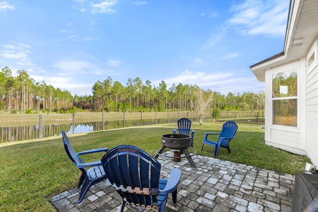 view of patio / terrace featuring a water view and a fire pit