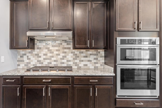 kitchen featuring decorative backsplash, dark brown cabinetry, and stainless steel appliances