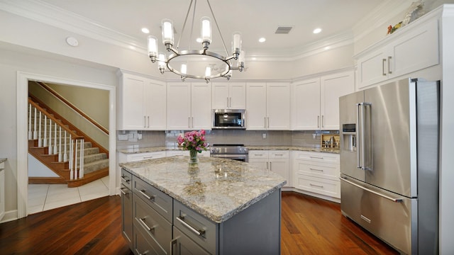 kitchen with ornamental molding, appliances with stainless steel finishes, gray cabinets, and visible vents