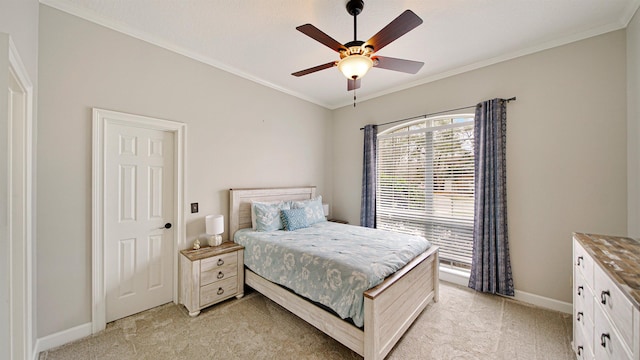 bedroom featuring light carpet, ceiling fan, baseboards, and crown molding