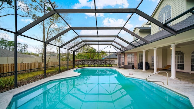 view of pool with a fenced in pool, a patio, a ceiling fan, glass enclosure, and fence