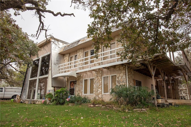 rear view of property with a lawn