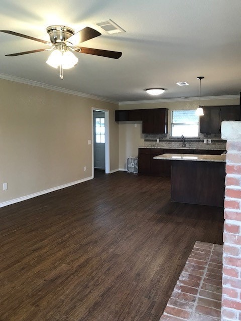 kitchen with ceiling fan, decorative light fixtures, dark brown cabinetry, ornamental molding, and dark hardwood / wood-style floors