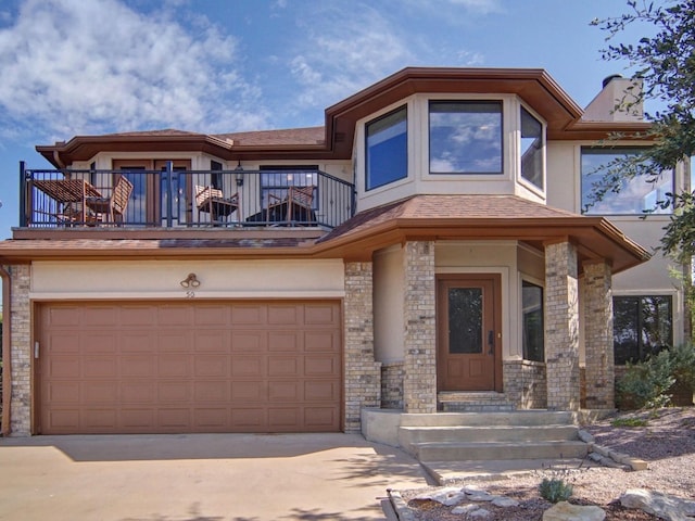 view of front facade featuring a balcony and a garage