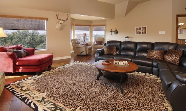 living room featuring an inviting chandelier and dark hardwood / wood-style flooring