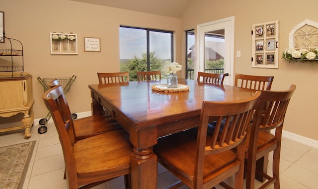 tiled dining room with lofted ceiling