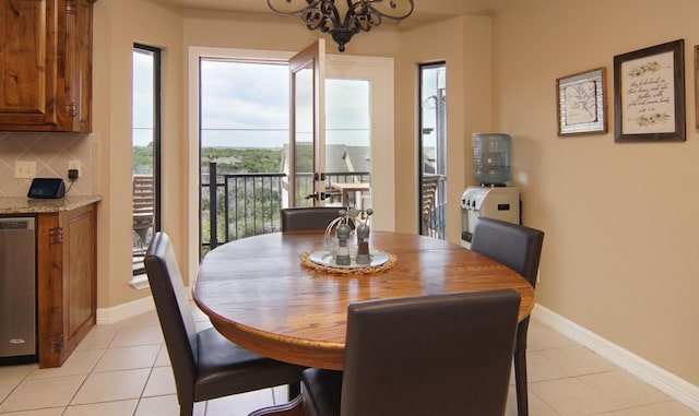 tiled dining area featuring an inviting chandelier