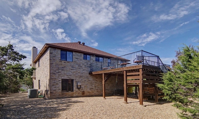 back of house with a wooden deck and central AC