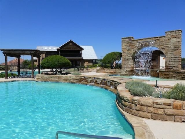 view of swimming pool with pool water feature