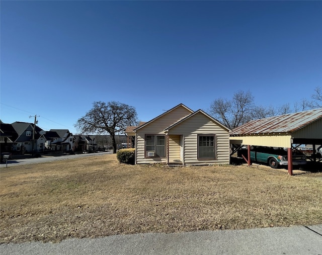 single story home featuring a front yard and a carport