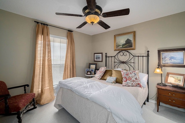 bedroom featuring light colored carpet and ceiling fan