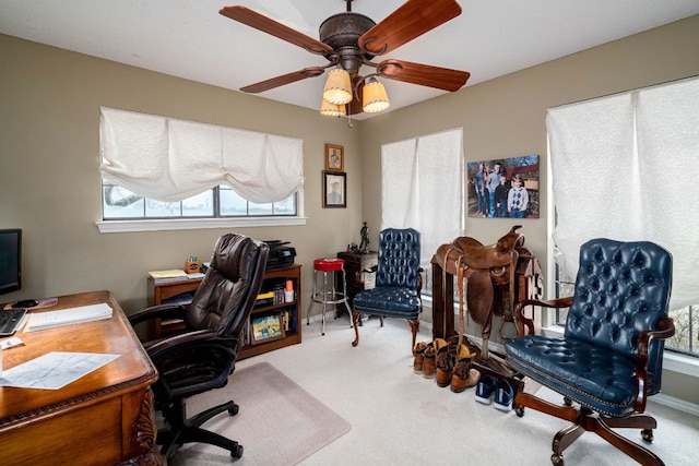 home office with ceiling fan and light carpet