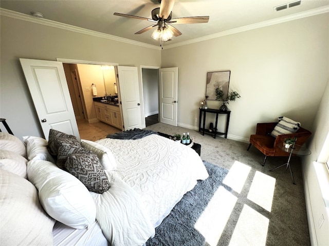 carpeted bedroom featuring ensuite bathroom, ceiling fan, and crown molding