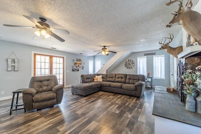 living room with ceiling fan, a textured ceiling, and dark hardwood / wood-style flooring