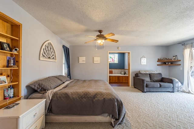 bedroom featuring light carpet, a textured ceiling, ensuite bath, and ceiling fan