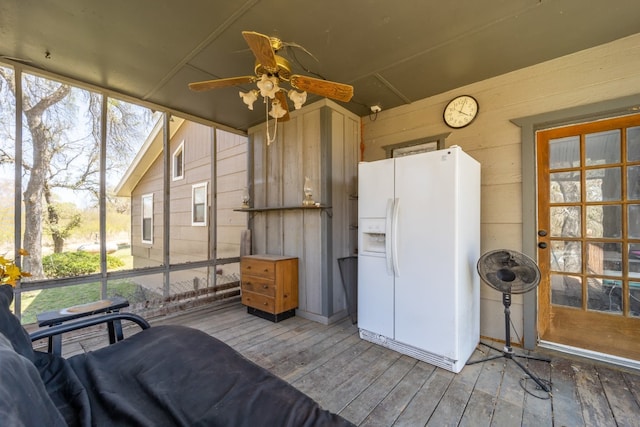 sunroom / solarium featuring ceiling fan and a wealth of natural light