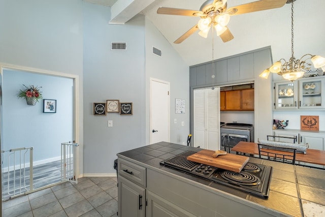 kitchen featuring high vaulted ceiling, ceiling fan with notable chandelier, light tile flooring, and gray cabinets