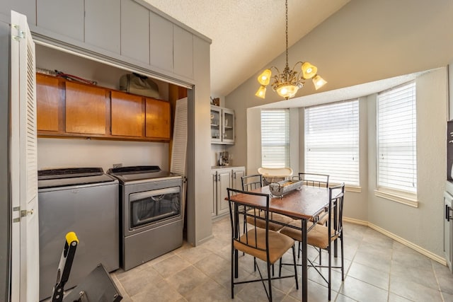 washroom featuring light tile floors, cabinets, a chandelier, and separate washer and dryer