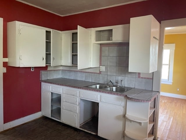 kitchen with white cabinets, backsplash, tile countertops, and dark hardwood / wood-style floors