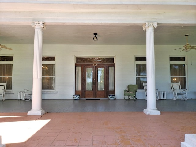 entrance to property featuring a porch and ceiling fan