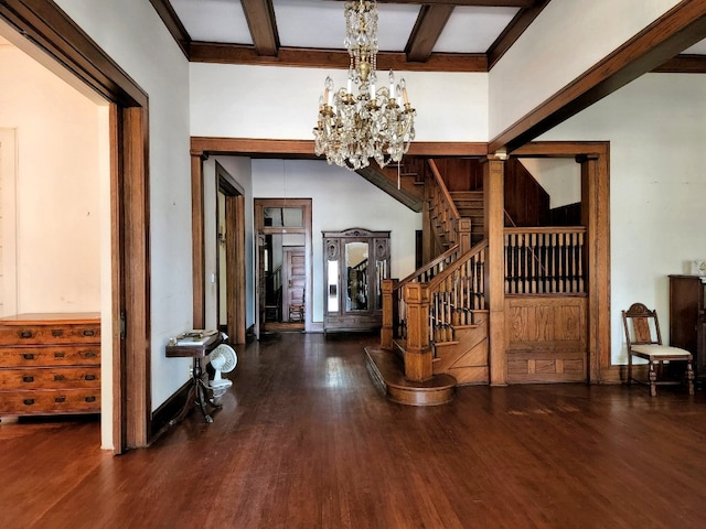 foyer with a chandelier, dark wood-type flooring, and beam ceiling