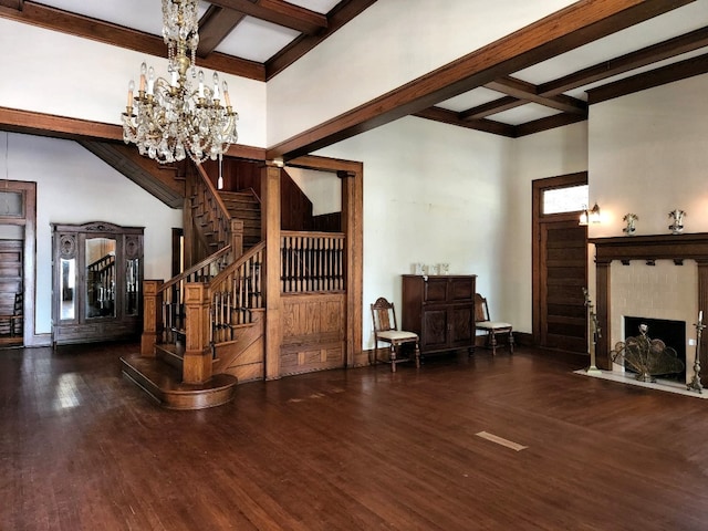 interior space featuring an inviting chandelier, dark wood-type flooring, and beamed ceiling