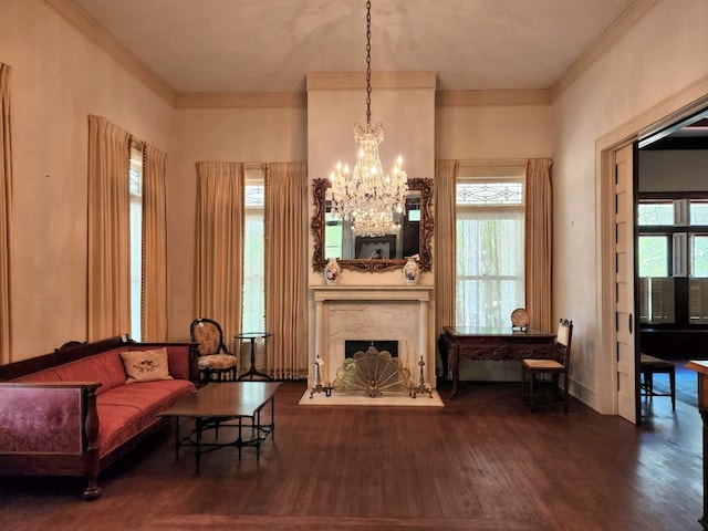 living room with dark hardwood / wood-style floors, a fireplace, a chandelier, and a wealth of natural light