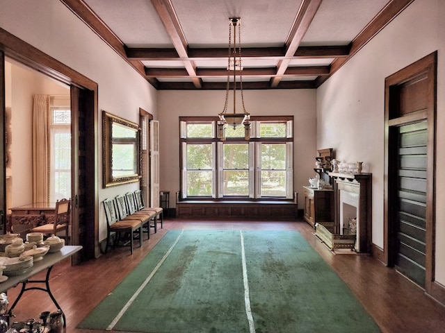 interior space with coffered ceiling, a fireplace, dark hardwood / wood-style floors, and beam ceiling