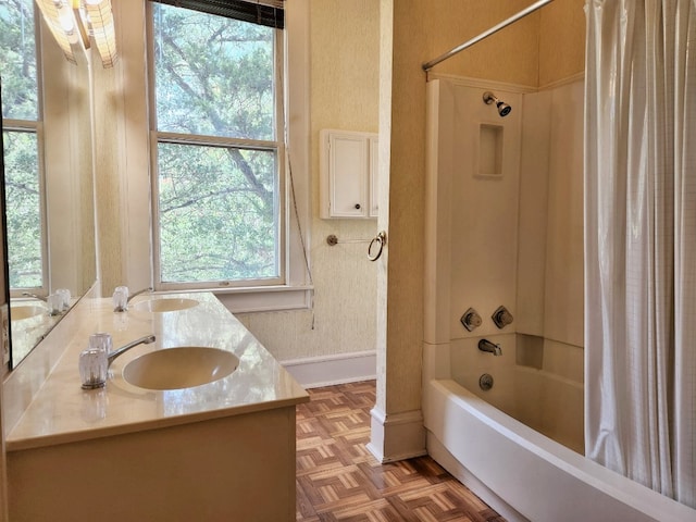 bathroom with shower / bath combination with curtain, double sink, parquet floors, and plenty of natural light