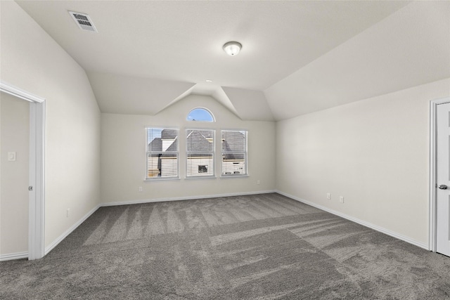 bonus room featuring dark carpet and lofted ceiling