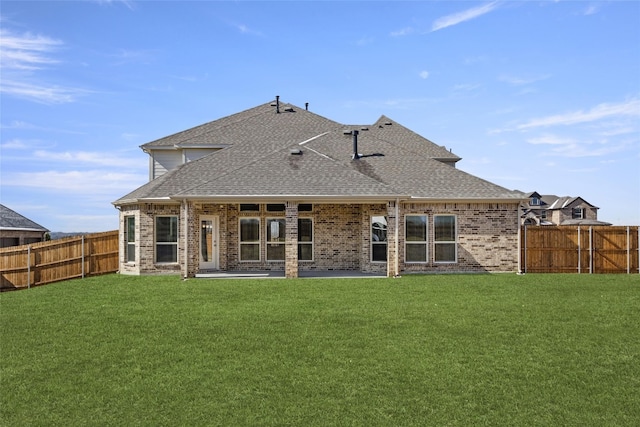 rear view of property featuring a patio and a lawn