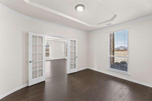 unfurnished room with french doors, dark wood-type flooring, a tray ceiling, and ornamental molding