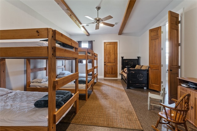 bedroom with a wood stove, ceiling fan, and beam ceiling