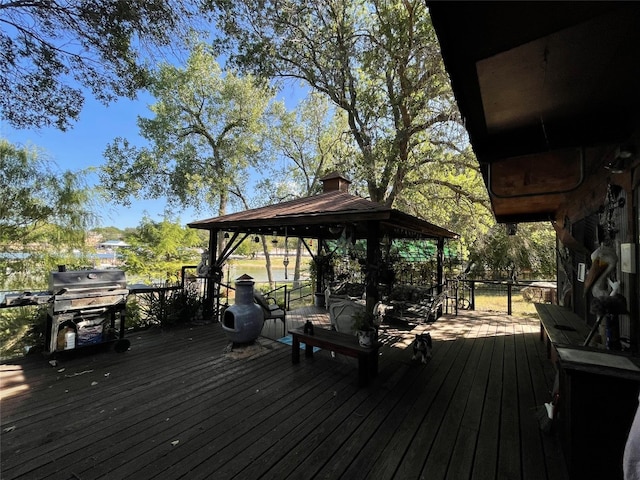 wooden deck featuring a gazebo and area for grilling