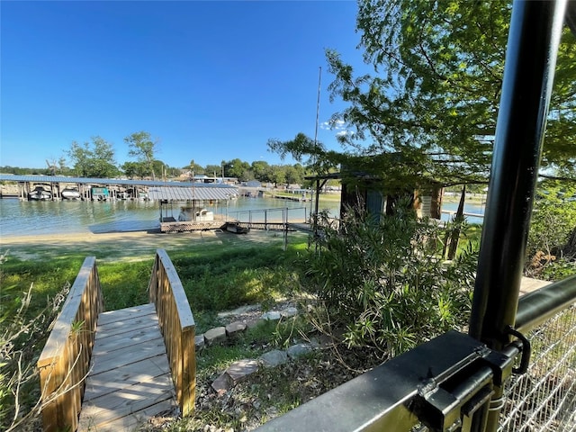 view of property's community with a dock and a water view