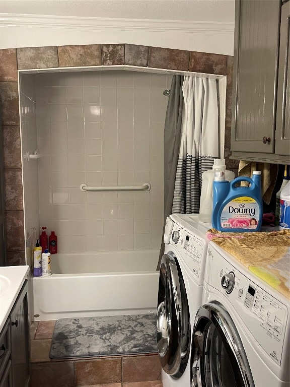 washroom featuring tile flooring, separate washer and dryer, and ornamental molding