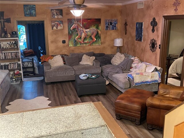 living room with ceiling fan, dark wood-type flooring, and ornamental molding