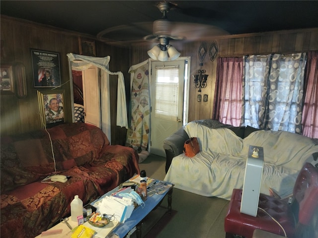 living room featuring wood walls and ceiling fan