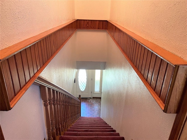 stairway featuring dark tile floors