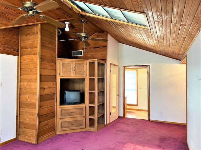 interior space with wood ceiling, dark carpet, and vaulted ceiling with skylight