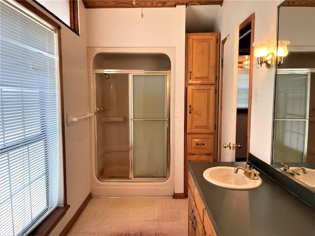 bathroom featuring tile flooring, a shower with door, and oversized vanity