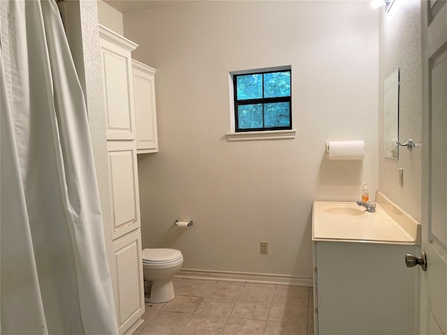 bathroom with tile flooring, toilet, and vanity