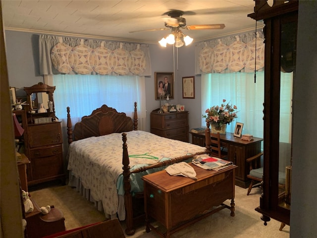 bedroom with light carpet, ceiling fan, and crown molding